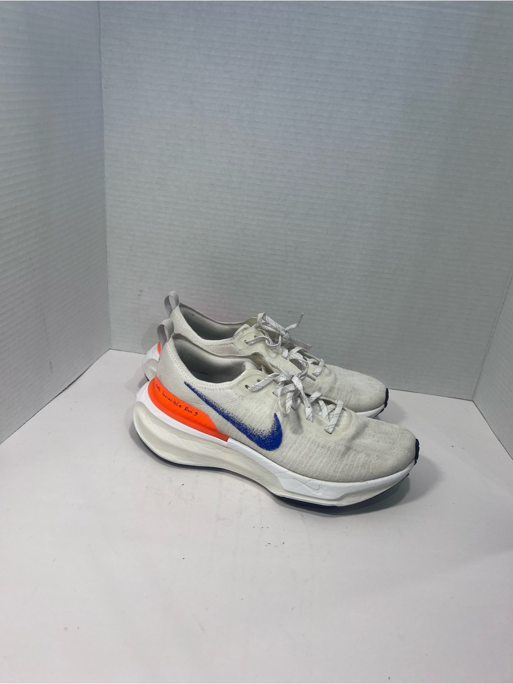 Nike White Sneakers with Blue Swoosh and Bright Orange Heel